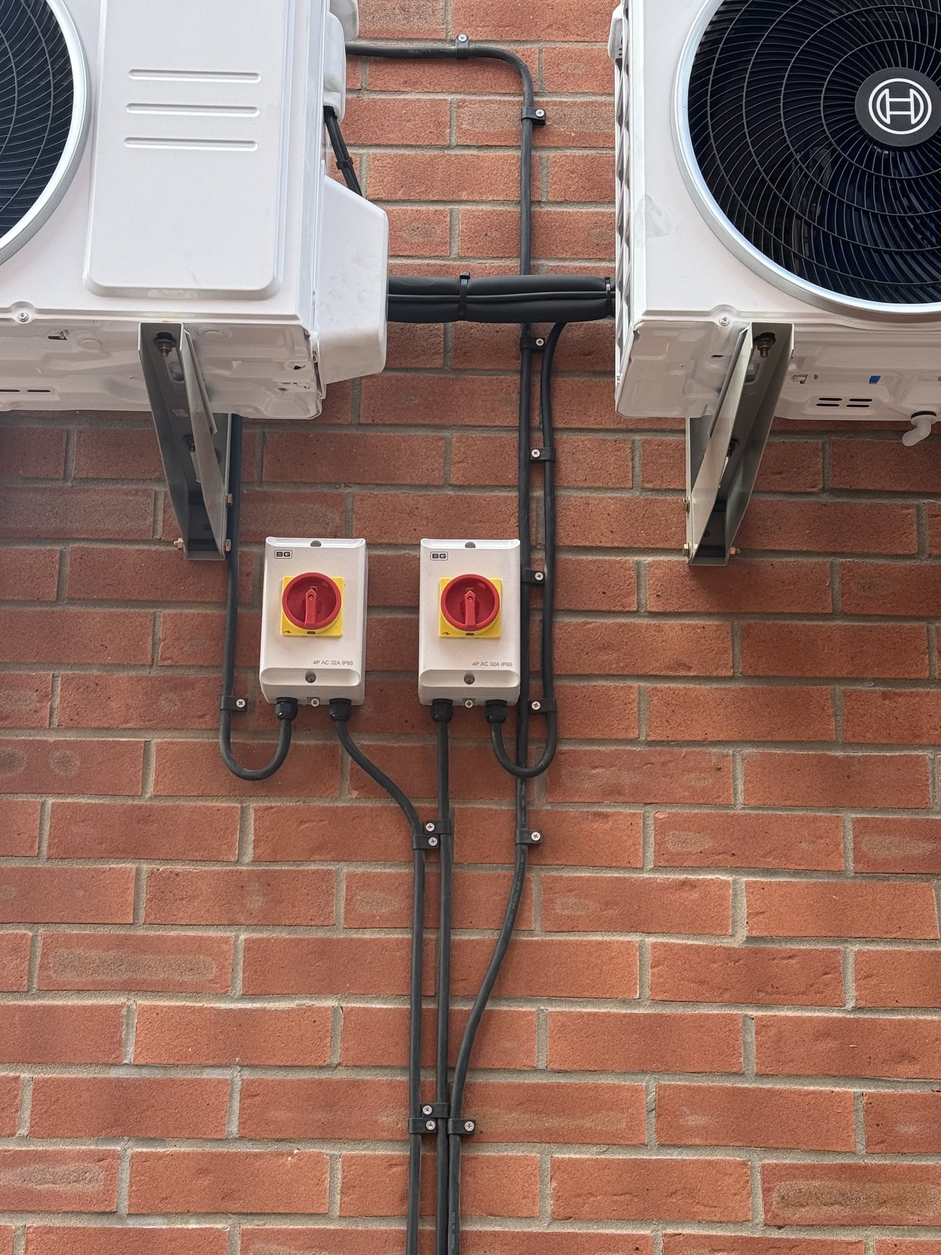 Two IP-rated rotary isolators supplying external air-conditioning condenser units
